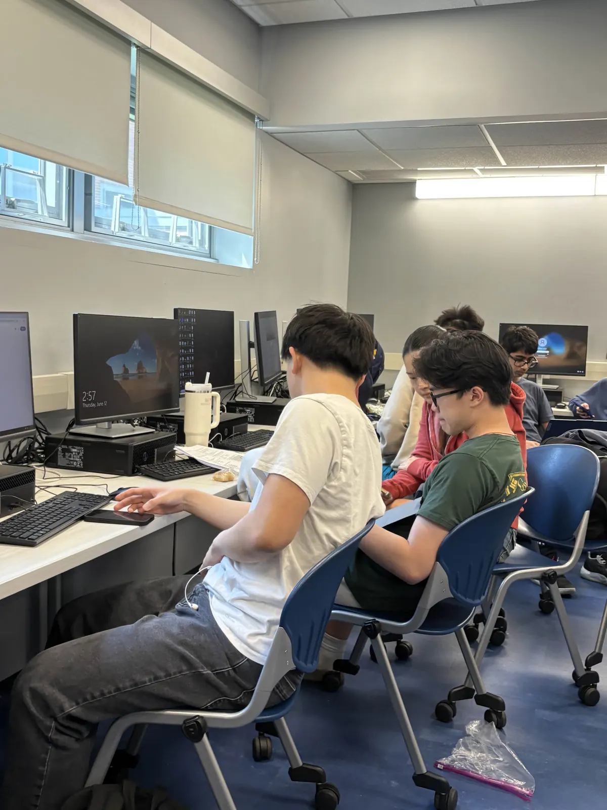 Members coding side by side at the lab desktops