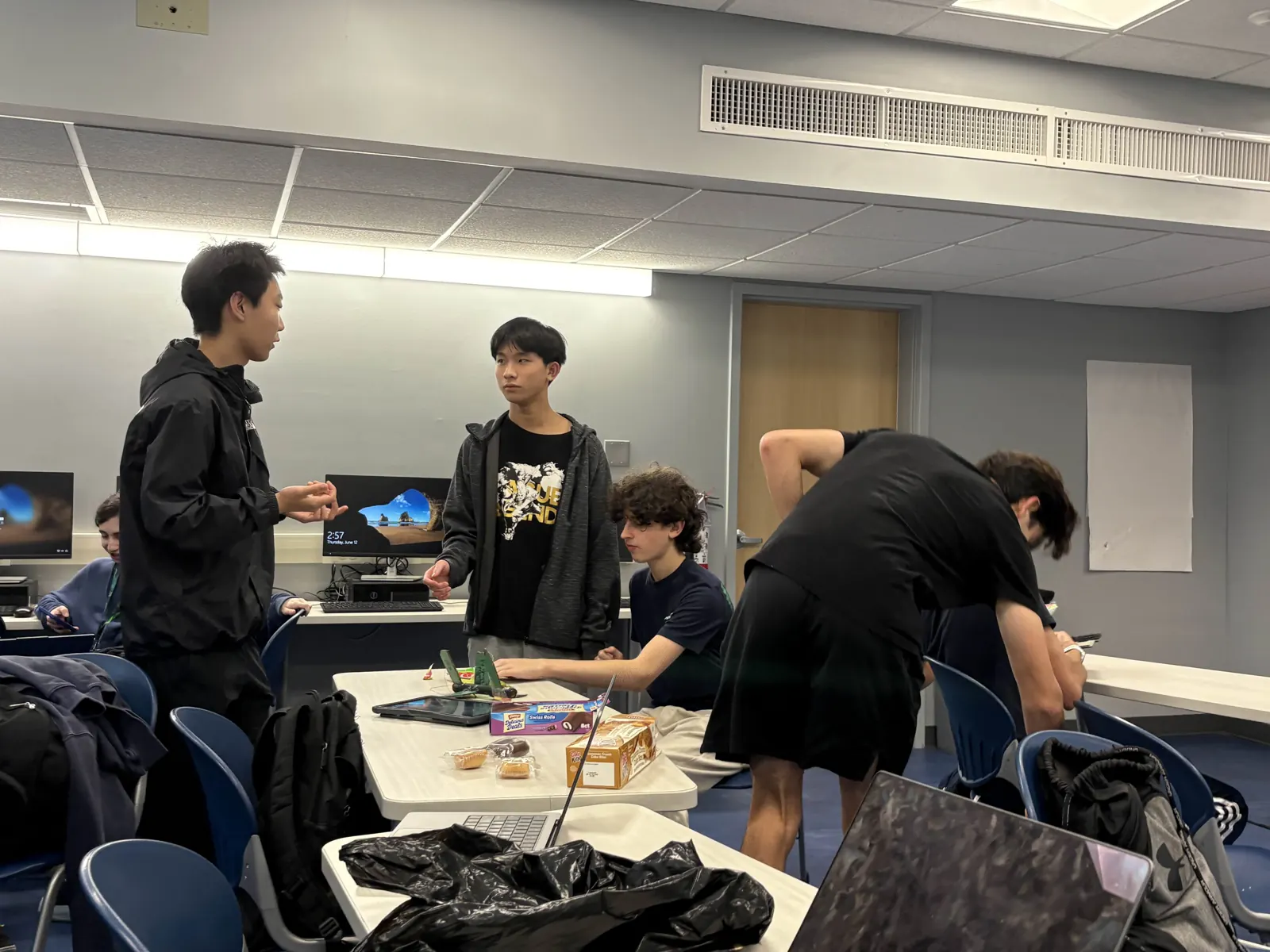 Members gathered around a table talking through a project