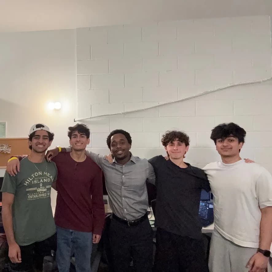 Five members standing together after a meeting